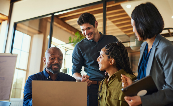 Enjoyable work meeting with four co-workers smiling